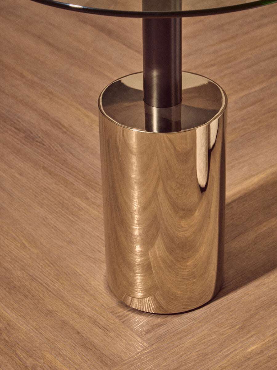 Orsina End Table with a sleek metallic base and glass top for modern living spaces
