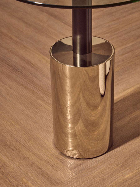 Orsina End Table with a sleek metallic base and glass top for modern living spaces
