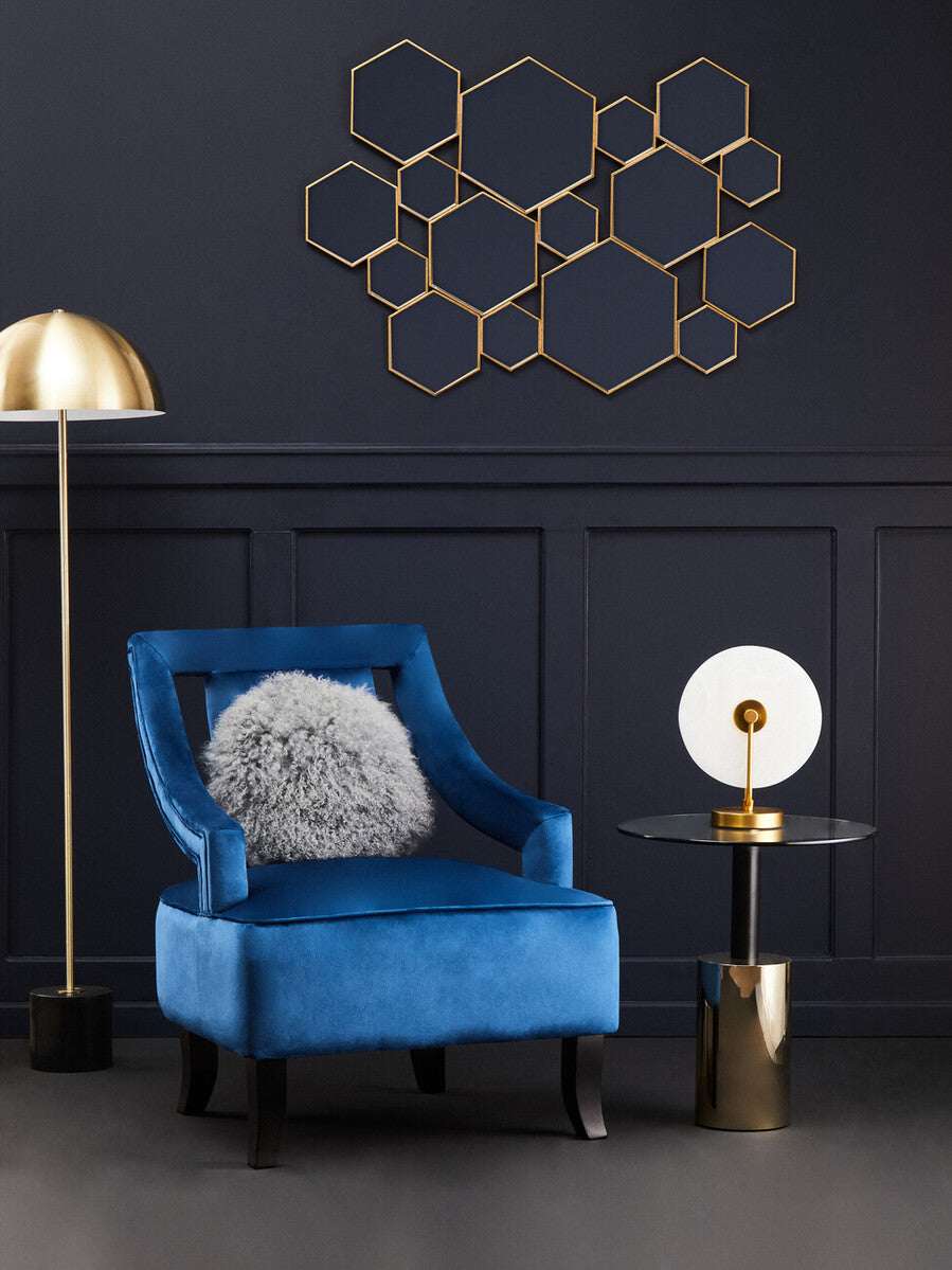 Orsina End Table with a sleek black top and gold base, styled beside a blue chair in a modern living room