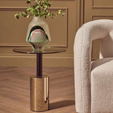 Stylish Orsina End Table with a gold base and glass top, featuring a modern vase of greenery