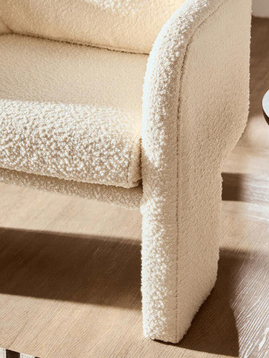 Orsina Fabric Armchair with a cosy texture and soft contours, perfect for modern living spaces