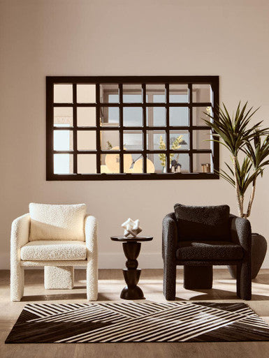 Two stylish Fabric Armchairs in cream and black, paired with a modern side table in a chic interior setting