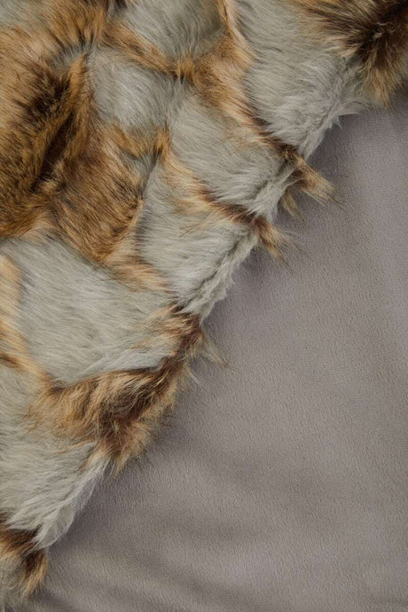 Orsina Fur Throw featuring a soft, luxurious texture in natural shades for cosy living spaces