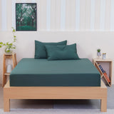 SHEET STORY Fitted Sheet in deep green colour on a wooden bed with matching pillows
