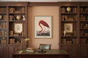 Framed Flamingo On Linen Artwork displayed in a classic library setting with wooden bookshelves