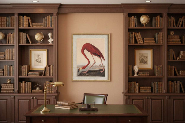 Framed Flamingo On Linen Artwork displayed in a classic library setting with wooden bookshelves
