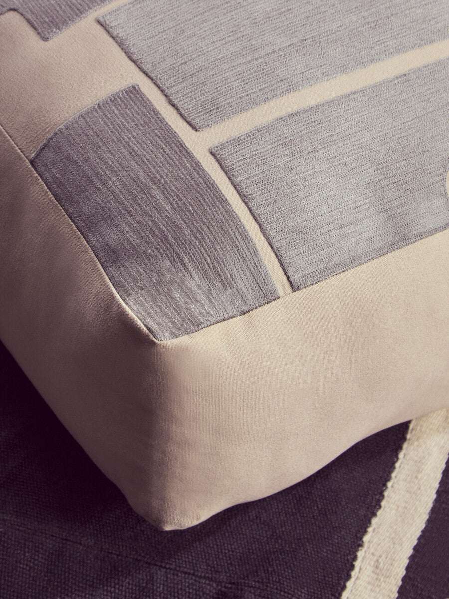 Orsina Floor Cushion with a modern design featuring textured grey and beige fabric for stylish seating