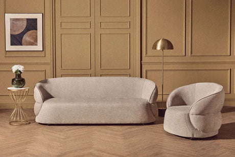 Orsina Floor Lamp in a stylish living room setting with a grey sofa and circular chair