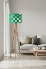 Shadow Bright green geometric lampshade on a wooden tripod lamp in a modern living room