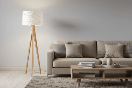 Stylish Shadow Bright lampshade on a wooden tripod floor lamp in a modern living room