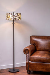 Orsina Floor Lamp with Unique Shade Design beside a Brown Leather Sofa in a Comfortable Living Room