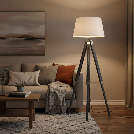 Orsina Floor Lamp with a stylish tripod design illuminating a cozy living room setting