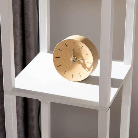 Stylish white bookcase with a wooden clock, perfect for displaying a floor lamp and home decor