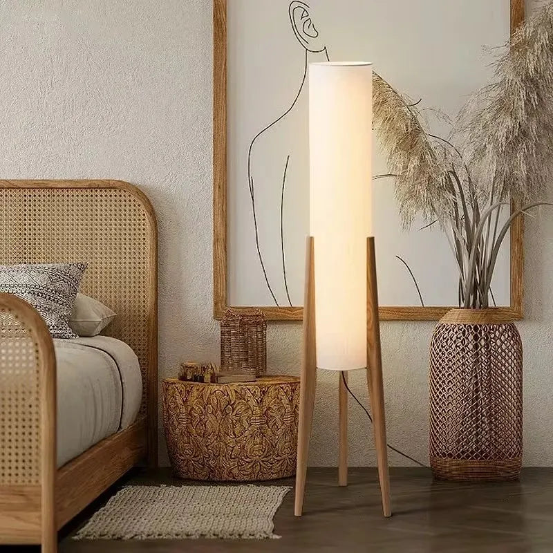Nisu Home Floor Lamp with a sleek design, enhancing a cozy bedroom atmosphere next to a rattan bed