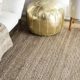 Stylish Nisu Home Floor Rug with a textured design under a modern sofa and pouf
