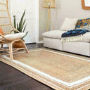 Natural Jute Floor Rug in a stylish living room setting with a sofa and decorative chair