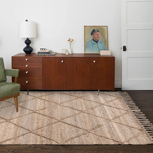Nisu Home Floor Rug in a natural weave with a geometric pattern on a wooden floor