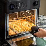Fridja Digital Air Fryer Oven with frying basket filled with golden fries