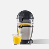 Fridja Citrus Juicer with sleek design pouring fresh orange juice into a glass