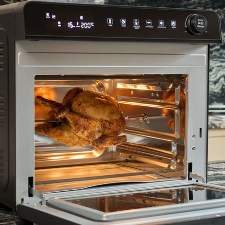 Fridja Digital Air Fryer with a whole chicken cooking inside for healthier meals