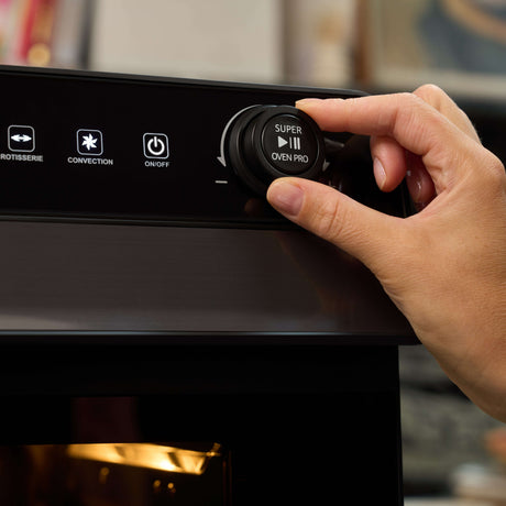User operating the Fridja Digital Air Fryer with dial for precise cooking control