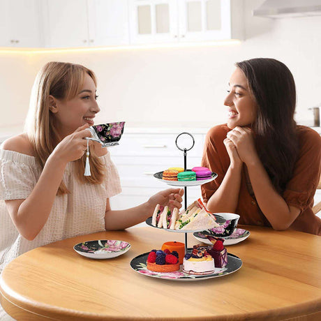 Elegant multi-tier cake stand with colourful desserts and tea cups in a stylish kitchen setting