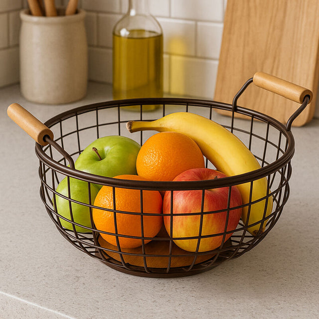 Stylish Orsina fruit basket with a mix of apples, bananas, oranges, and green apples on a kitchen counter