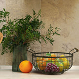 Orsina Fruit Basket with assorted fresh fruits including oranges, lemons, and grapes on a kitchen countertop