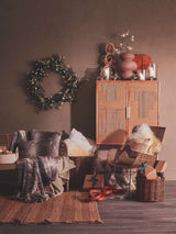 Stylish living room scene featuring Orsina Fur Cushion on a chair, with a warm decor atmosphere