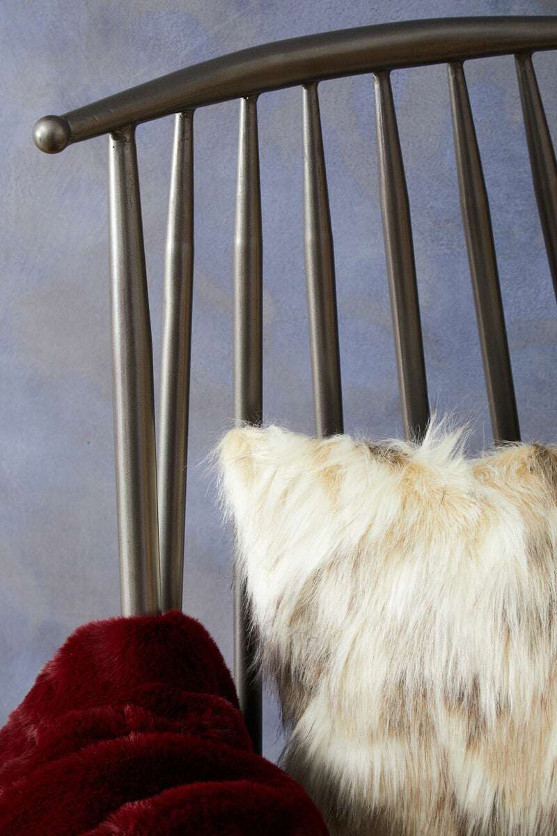 Soft and stylish Fur Cushion resting on a chair, perfect for adding comfort to any space