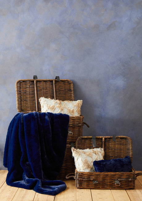 Orsina Fur Cushion in a stylish setting with woven baskets and a navy throw blanket