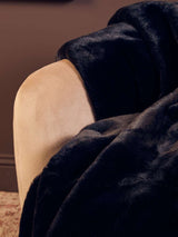 Luxurious Orsina Fur Throw in Deep Navy, perfect for adding warmth and style to your living space