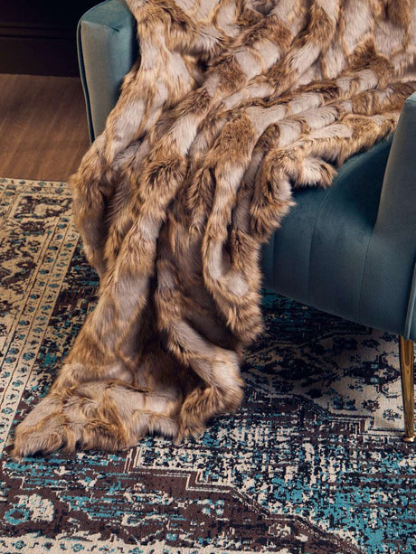 Luxurious Orsina Fur Throw draped over a stylish sofa, adding warmth and elegance to any living space