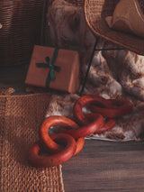 Orsina Fur Throw draped on a chair, complementing rustic decor with a wooden accessory nearby