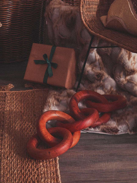Orsina Fur Throw draped on a chair, complementing rustic decor with a wooden accessory nearby