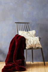 Orsina Burgundy Fur Throw Draped on Chair with Soft Faux Fur Cushions for Cozy Home Decor
