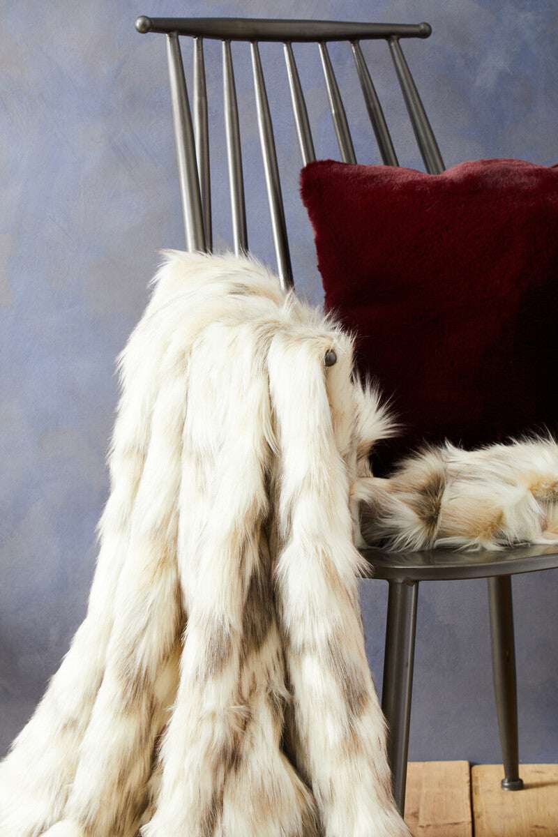 Orsina luxurious fur throw draped on a modern chair, perfect for adding warmth to any space