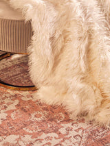 Orsina Fur Throw in Cream Colour Draped Over a Chair for Cozy Home Decor