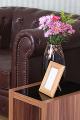 Stylish Nest of Tables from Orsina beside a brown leather sofa with a vase of flowers