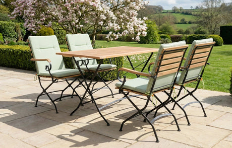 Stylish MINT Outdoor Garden Dining Set with four folding chairs and a wooden table in a scenic garden