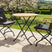 MINT Outdoor Garden Dining Set with two stylish chairs and a round table in a scenic garden