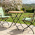 MINT Outdoor Garden Dining Set with two folding chairs and a round table in a scenic outdoor setting