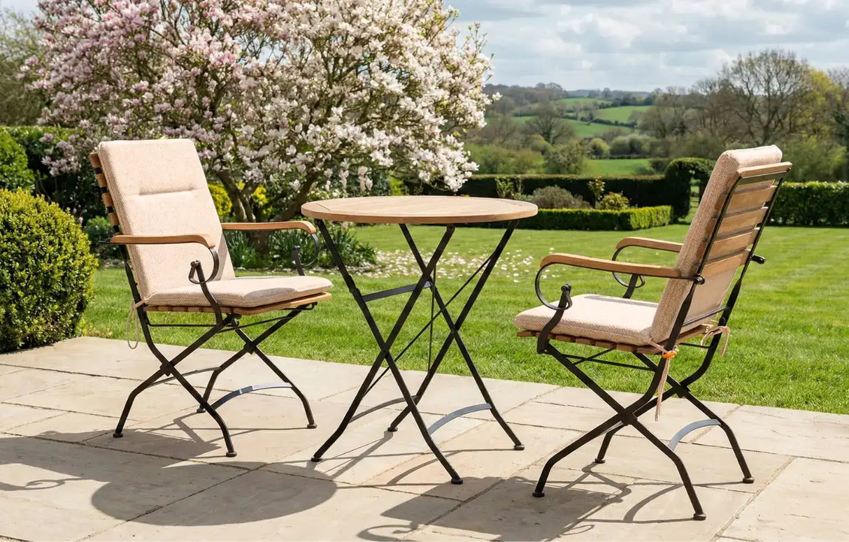 MINT Outdoor Garden Dining Set with Two Stylish Chairs and a Round Table in a Beautiful Garden Setting