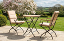MINT Outdoor Garden Dining Set with Two Stylish Chairs and a Round Table in a Beautiful Garden Setting