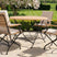 MINT Outdoor Garden Dining Set with a round wooden table and four stylish folding chairs