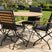 MINT Outdoor Garden Dining Set featuring a round wooden table and five foldable chairs for outdoor gatherings