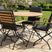 MINT Outdoor Garden Dining Set featuring a round wooden table and five foldable chairs for outdoor gatherings