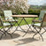 MINT Outdoor Garden Dining Set with Round Table and Four Folding Chairs in a Scenic Outdoor Setting
