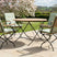 MINT Outdoor Garden Dining Set with Round Table and Four Folding Chairs in a Scenic Outdoor Setting