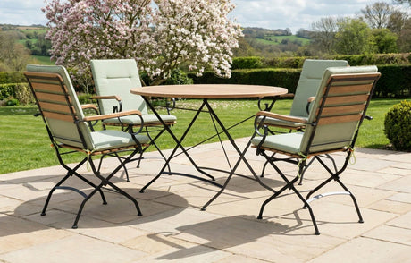 MINT Outdoor Garden Dining Set with Round Table and Four Folding Chairs in a Scenic Outdoor Setting